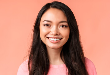 Fototapeta premium Attractive young woman smling on a pink background.