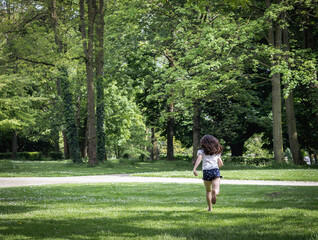 One running girl in the park on a summer day.