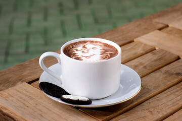 a cup of hot chocolate served with chocolate chips