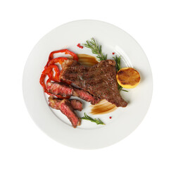 Delicious grilled beef steak with pepper, spices and lemon isolated on white, top view