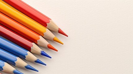 Obraz premium Brightly colored pencils arranged in a gradient from red to blue on a white background