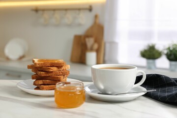Breakfast served in kitchen. Fresh toasts, coffee and honey on white marble table