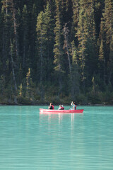 Canoe in the clear water mountain lake 