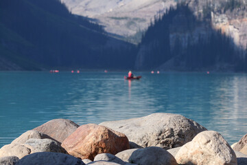 Canoe in the clear water mountain lake 