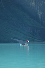 Canoe in the clear water mountain lake 