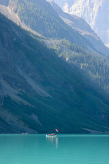 Canoe in the clear water mountain lake 