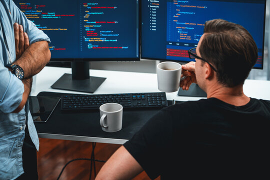 IT developers discussing online software development information on pc screen, creating program coding for latest version application on website. Concept of brainstorming firmware updated. Sellable.
