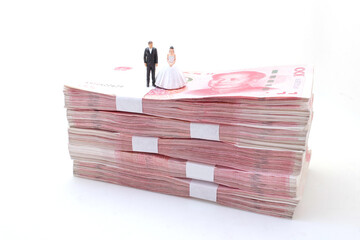 the bride and groom on Stacks of Chinese Yuan Banknotes