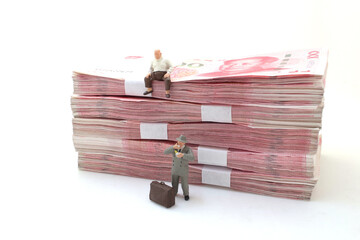 business man stand on Stacks of Chinese Yuan Banknotes,