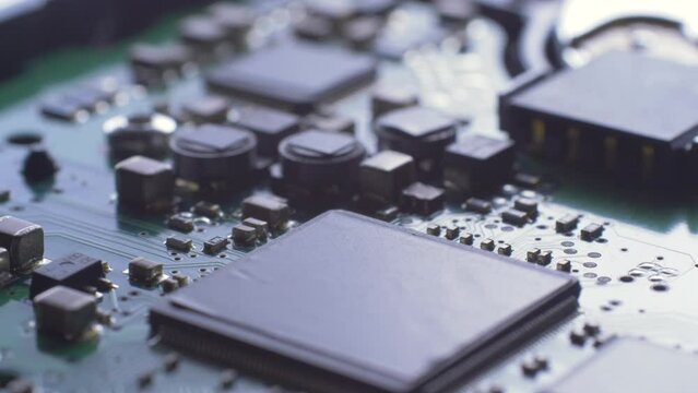 Green electric circuit board PCB background. Many electrical components. Computer hardware technology concept