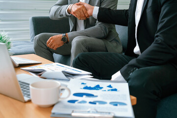 Businessman handshake with another businessman partner in modern workplace office. People corporate...