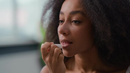 African American beauty female routine make-up apply natural smooth moisturize lipstick ethnic biracial woman lady girl applying lips balm skin care makeup moisturizing cosmetic product lip gloss