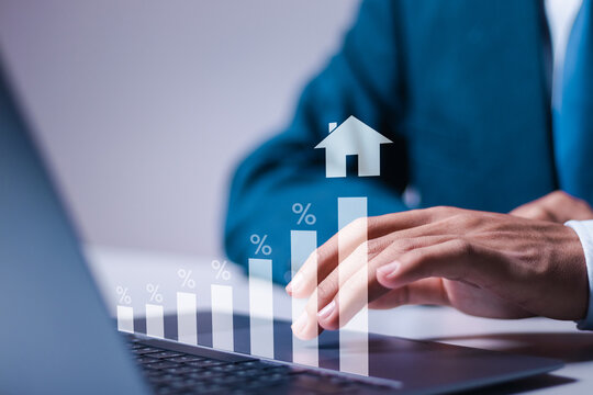 Real estate investment concept. Person use laptop with virtual house icon and growth graph for analyzing mortgage loan home and insurance real property mortgage. interest rate, Investment planning.
