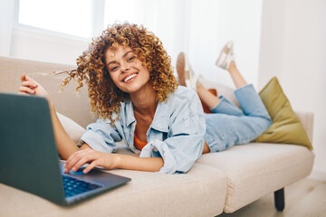 Smiling Woman Typing on Laptop, Enjoying Freelance Job in Cozy Home Office