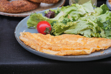  Egg Omelette served with salad on table 
