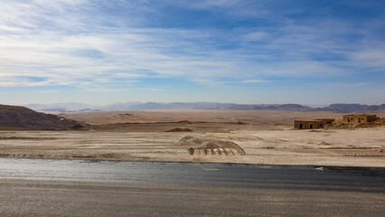 Scenic landscape view overlooking remote road and dry, arid desert and mountainous terrain in Jordan, Middle East