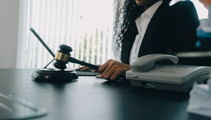 Judge gavel with Justice lawyers having team meeting at law firm background. Concepts of Law and Legal services.