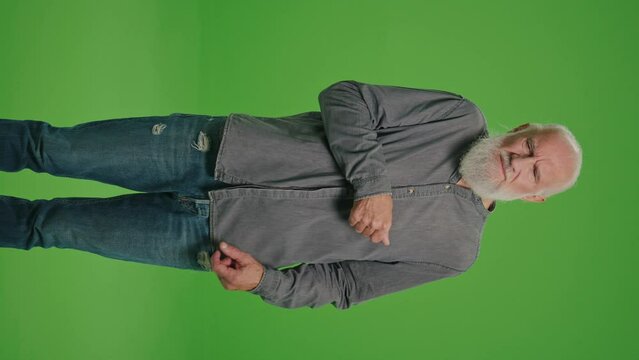 Vertical View.Green Screen.A Portrait of An Old Man with a Sore Elbow. An Elderly Man Feeling Sick, Having Painful Elbow Feelings and Gives Himself a Massage.Fight Against Senile Diseases.