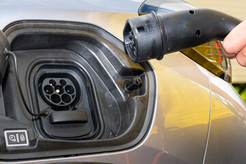 close up of type 2 CCS plug and socket on a grey electric car