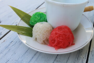 Indonesian food called putu mayang of vermicelli in plates and cups on the table