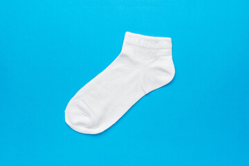 A bright white sock on a blue background.
