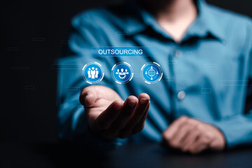 Outsourcing concept. Human resources and global recruitment for business. Person hold virtual outsourcing icon for business working and company.