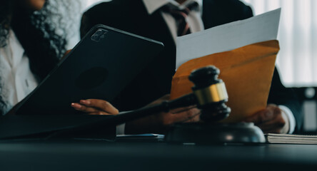 Judge gavel with Justice lawyers having team meeting at law firm background. Concepts of Law and...