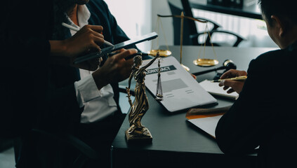 Judge gavel with Justice lawyers having team meeting at law firm background. Concepts of Law and Legal services.