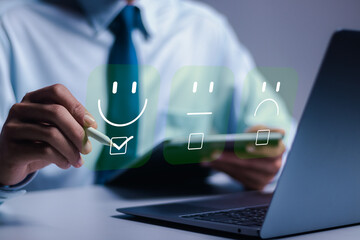 Customer experience concept. Businessman use laptop choose face emoticon smile for service,...