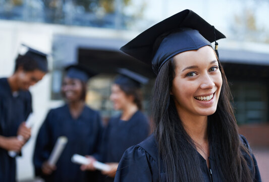 Woman, student and portrait at graduation, milestone and university success or achievement. Happy female person, smile and pride at outdoor ceremony, higher education and knowledge in qualification