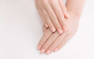 Stylish trendy nail young woman hands pink manicure on white background