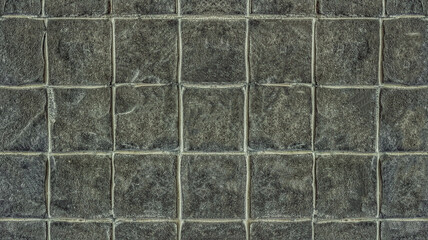 Dark gray tile wall for seamless tiles background and texture.
