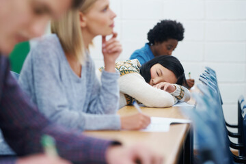 Student, university and sleeping on desk in classroom for boring lecture or burnout, fatigue or...