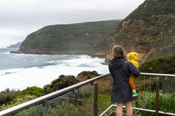 ocean lookout looking out over waves and rocks in the rain in australia