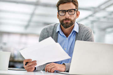 Businessman, portrait and laptop with paperwork in finance, budget planning or investment at office. Man, accountant or employee with documents, financial report or policy by computer at workplace