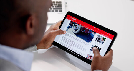 Reading Newspaper Article On Tablet