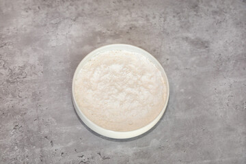 A white bowl with sugar free and zero calorie confectioners sugar replacement.