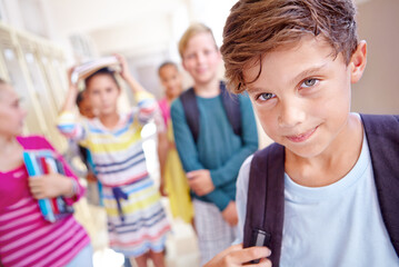 Students, portrait and boy with smile in hallway with education, study or backpack for back to...