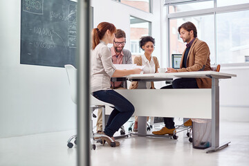 Business people, planning and meeting in office, diversity and brainstorming on project for decision. Men, women or communication with paperwork on table, problem solving or consultant in company