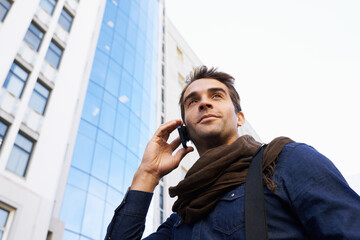 Man, city and buildings with smartphone for phone call, conversation or networking in Chicago. Male...