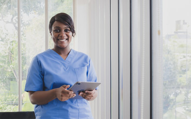 Portrait woman doctor nurse carer physical therapist black African-American one people smile stand...