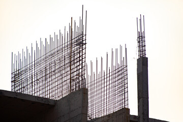 Buildings under construction. Abandoned building. Steel frame, building pillars.