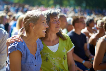 Mature, women and friends by festival look happy, outdoors and holiday in Amsterdam. Music concert,...