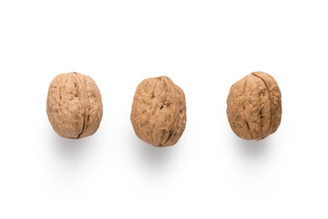 Three walnuts top view on white background