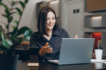 Young female use notebook student doing assignments in cafe, student lifestyle.