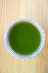 Cup of Hot Japanese Matcha Green Tea Isolated on Wooden Table
