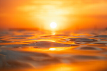 Water surface with golden sunlight reflection.
