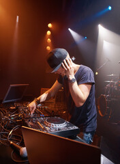 DJ, headphones and audio on stage for sound check with turntables at concert in Australia. Male...