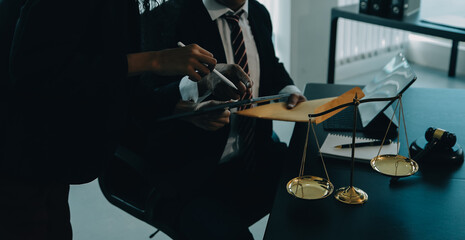 Judge gavel with Justice lawyers having team meeting at law firm background. Concepts of Law and Legal services.