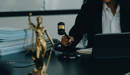 Judge gavel with Justice lawyers having team meeting at law firm background. Concepts of Law and Legal services.